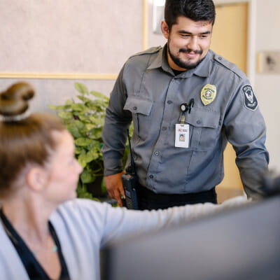 Security Officer working with staff