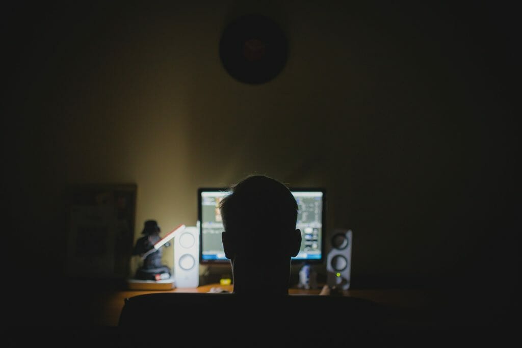 Man at computer at night